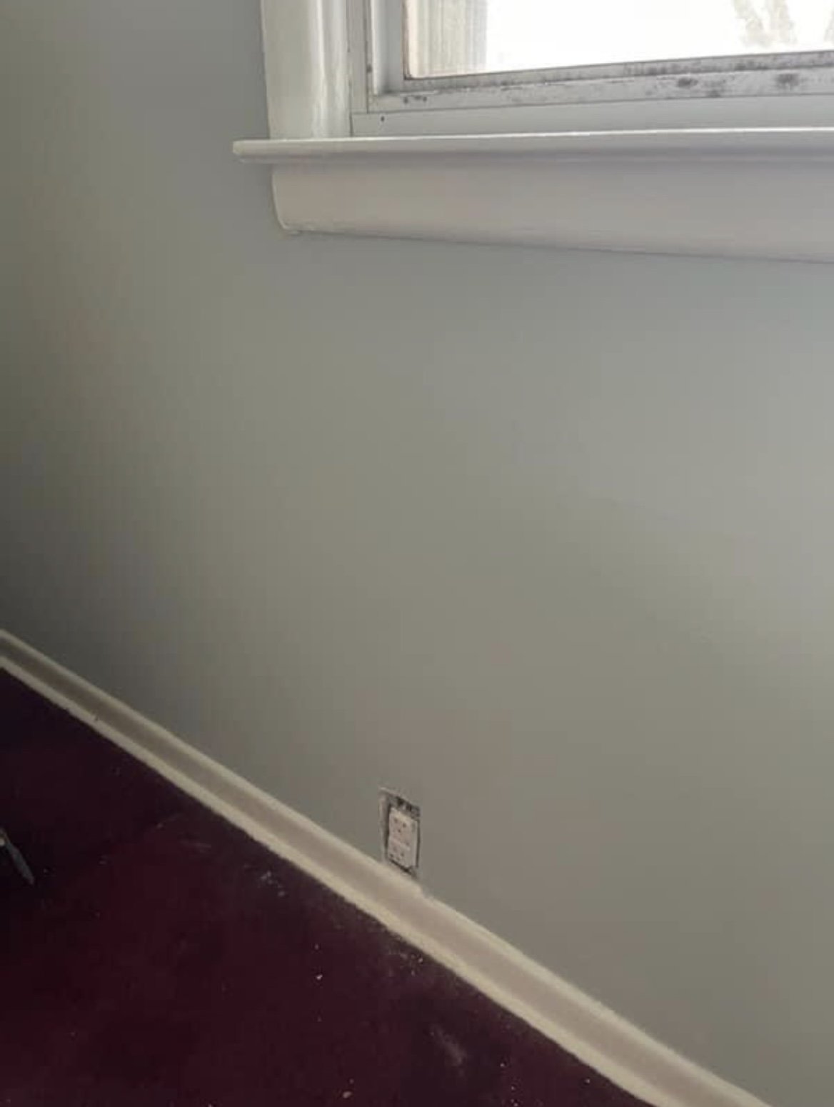 A water-damaged wall after RFCP repaired and repainted it in a fresh gray-green